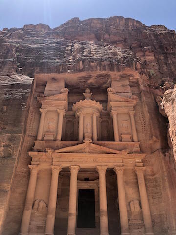 The rock-cut facade of Al-Khazneh (The Treasury) in Petra, Jordan, rises majestically against a clear sky.