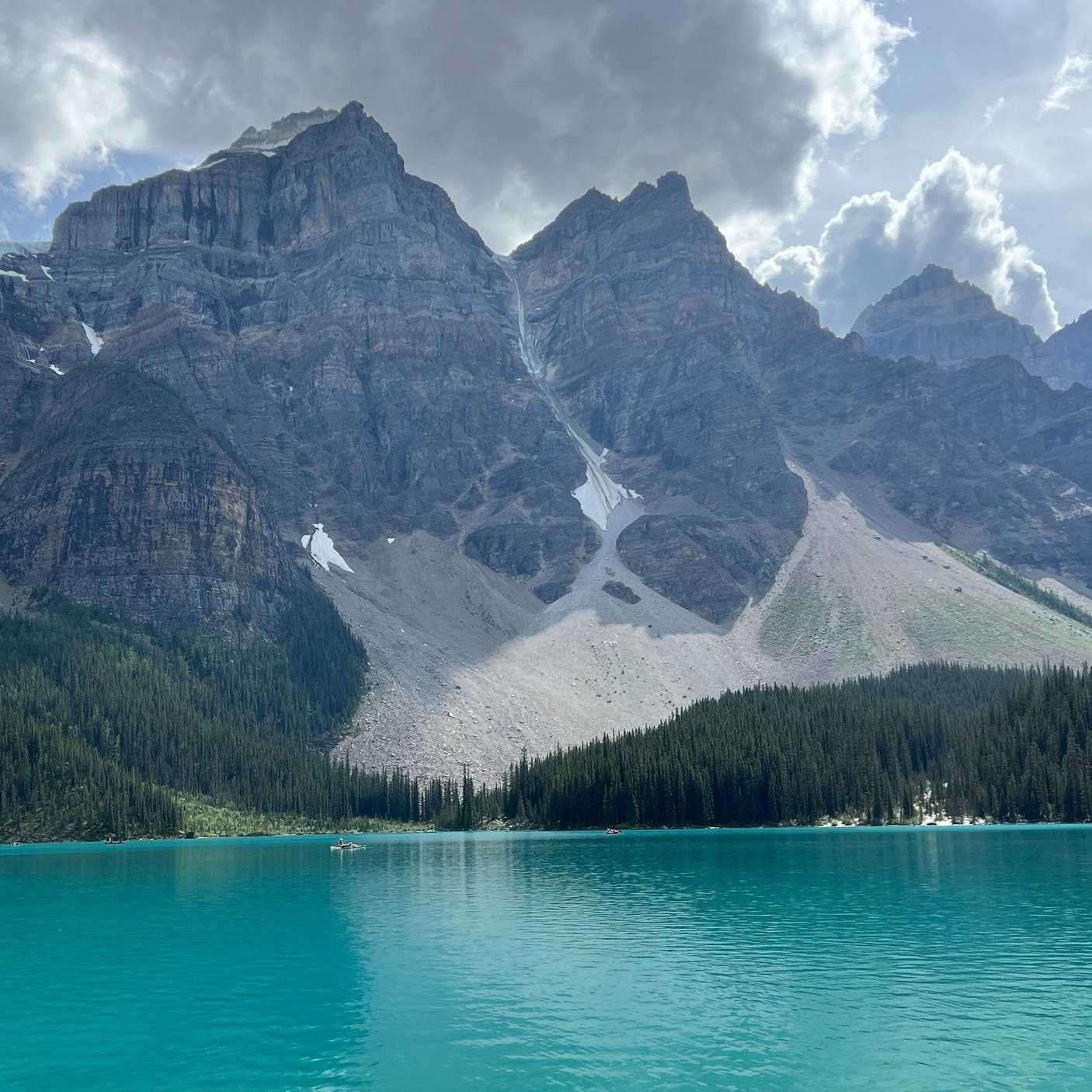 A turquoise blue lake and large mountains beyond at Banff National Park