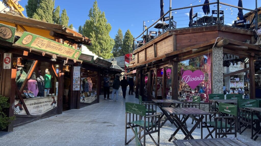 Outdoor shopping area with wooden storefronts, perfect for relaxing during your Patagonia itinerary or 1 week itinerary adventure.