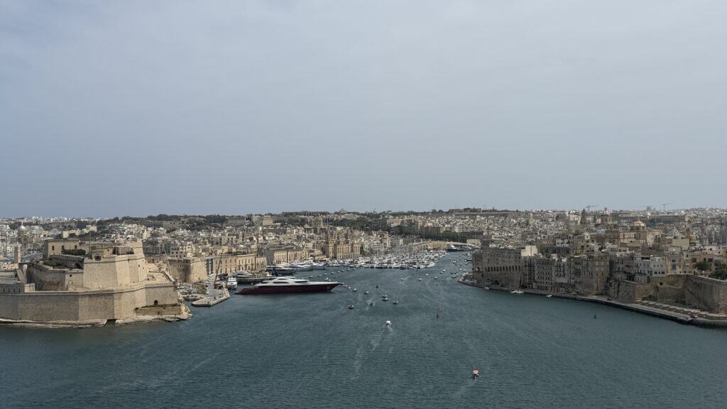 A wide view of a harbor city in Malta, with stone buildings and yachts—perfect for your Malta travel or 3 day Malta itinerary.