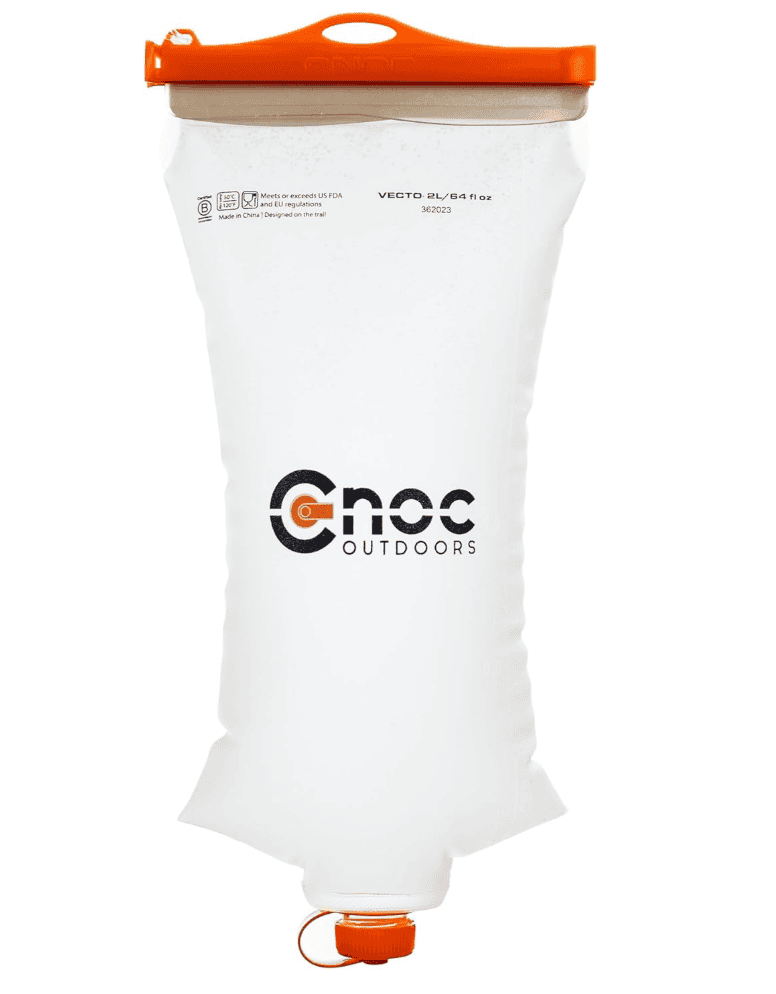 A clear, soft-sided water container with an orange cap—essential backpacking gear for Pacific Crest Trail adventurers.