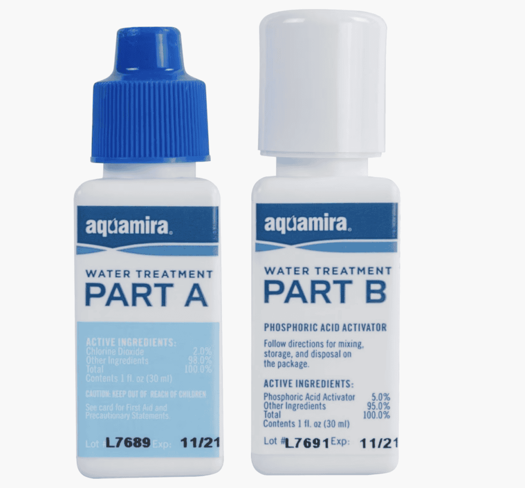 Two bottles labeled Aquamira Water Treatment, perfect for backpacking or Pacific Crest Trail adventures, showing ingredients and expiration dates.