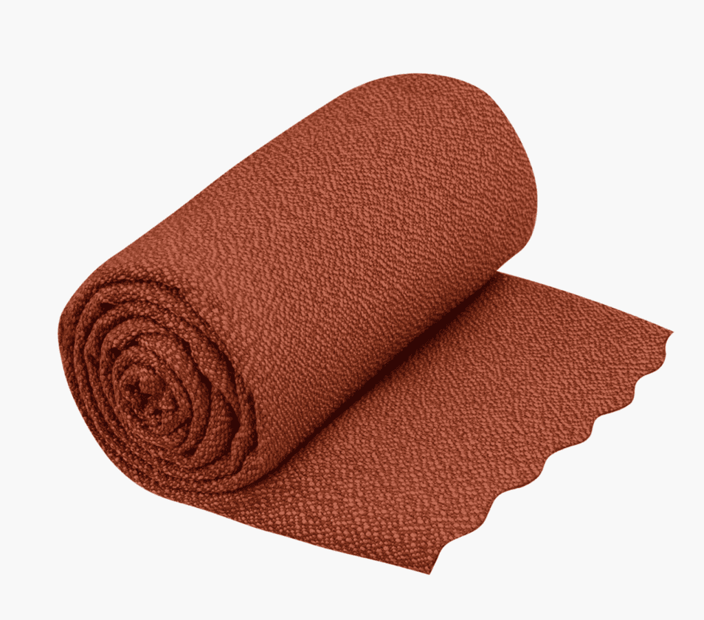 A roll of textured, reddish-brown fabric with a wavy-cut edge—perfect for backpacking gear on the Pacific Crest Trail.