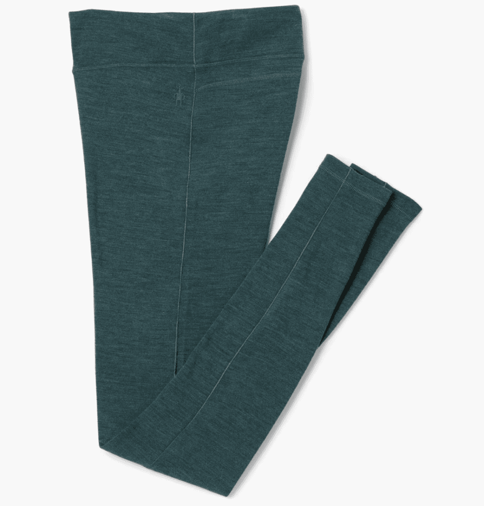 A pair of teal blue leggings, perfect for Pacific Crest Trail adventures, with a small stitched logo near the waistband, folded neatly.