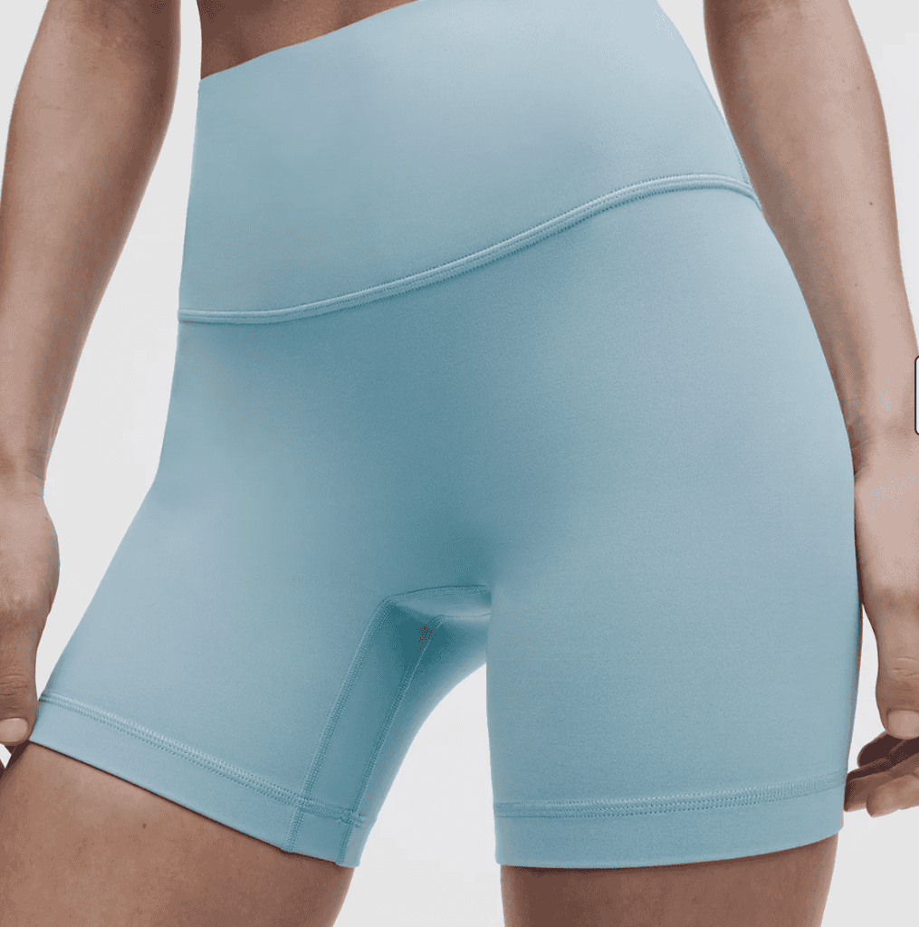Person wearing light blue high-waisted athletic shorts, perfect for hiking or tackling the Pacific Crest Trail, shown from waist to mid-thigh.
